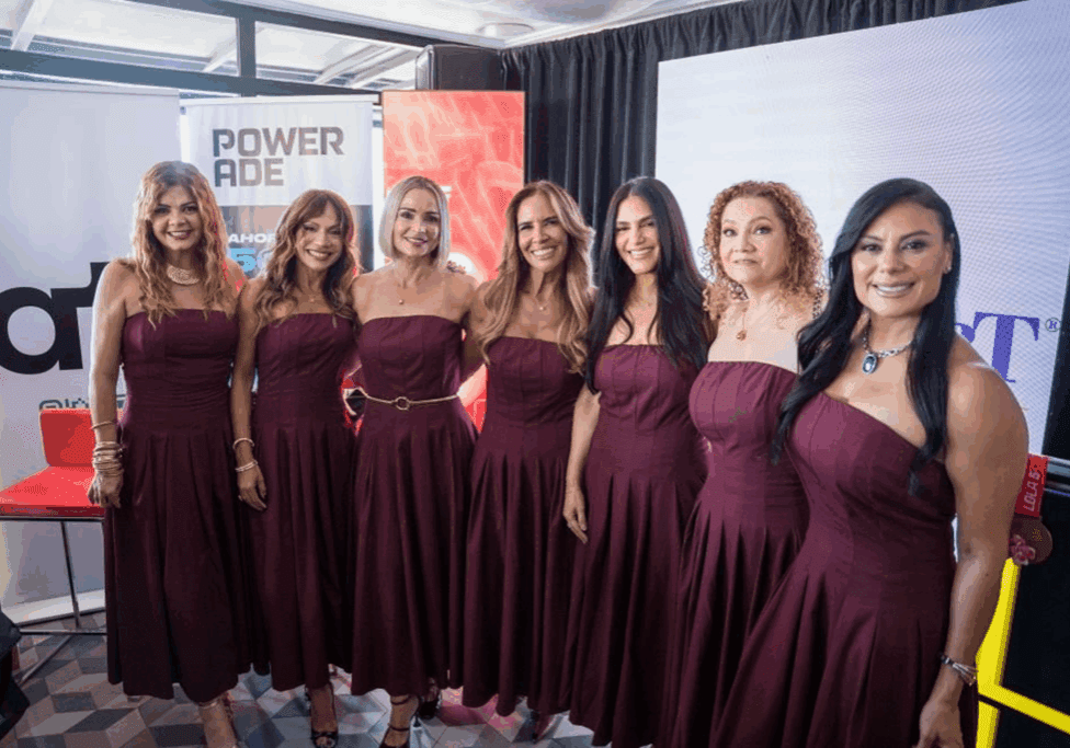 Group of women in matching burgundy dresses.