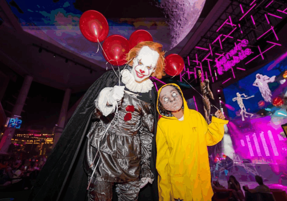 Clown and child in Halloween costumes